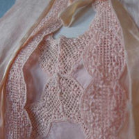 close up detail of scalloped net lace trim on nightgown and bedjacket