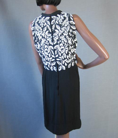 back view, 60s black sheath with extensive white beading and bling