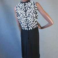 back view, 60s black sheath with extensive white beading and bling