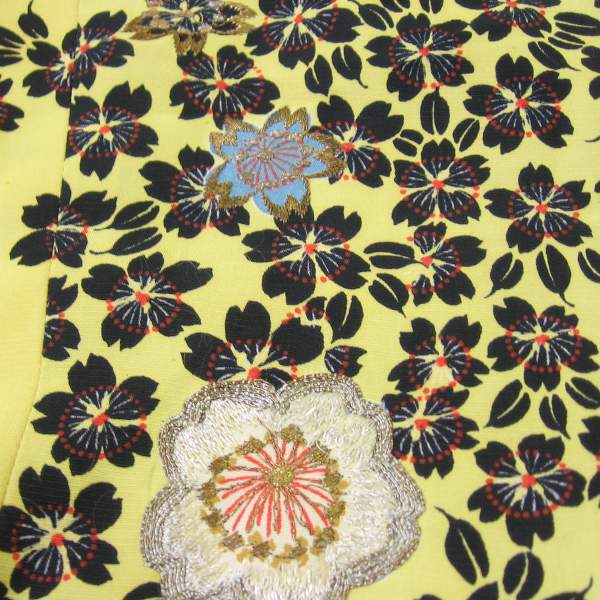 detail of floral print fabric with metallic embroidery enhancement