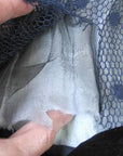 close up of deteriorated middle layer of gossamer fabric inside sleeve 