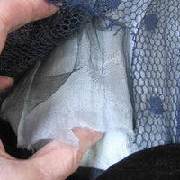 close up of deteriorated middle layer of gossamer fabric inside sleeve 