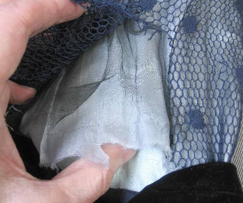 close up of deteriorated middle layer of gossamer fabric inside sleeve 