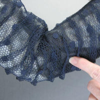 close up detail showing an area where black gossamer middle fabric layer bunched together