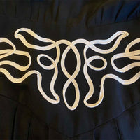 close up view of soutache braid swirling accent on wide waist