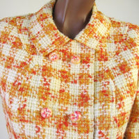 close up detail, orange and yellow plaid suit jacket with candy colored buttons