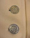 close up of metal lattice pattern buttons, 60s 70s cape