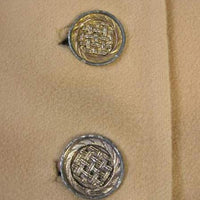 close up of metal lattice pattern buttons, 60s 70s cape