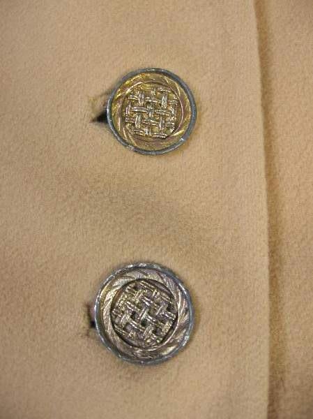 close up of metal lattice pattern buttons, 60s 70s cape