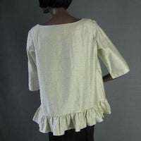 back view of trapeze shape ruffle edged blouse top
