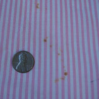 close up detail, tiny rust stains on 40s pink pinafore dress