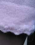 detail, feminine stitching cuff of pink pullover