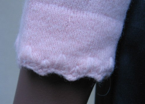 detail, feminine stitching cuff of pink pullover