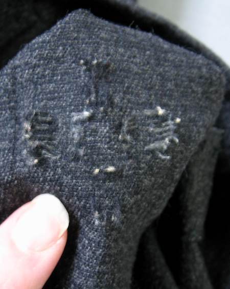 detail closeup inside reweaving repair pants knee