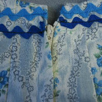 closeup detail floral blue and whie print with rick rack