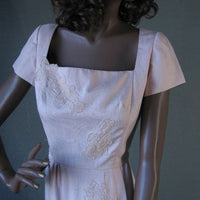 bodice of 1950s pink dress with lace appliques
