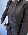 angled view of Suzy Creamcheese jacket, with button and loop closure and floral braid embellishment