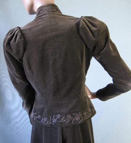 back view of jacket, with embellished peplum, puffed shoulders, and stand up collar