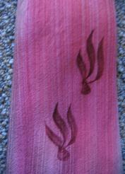 close up detail, painted flame motifs on silk ombre raspberry pink necktie