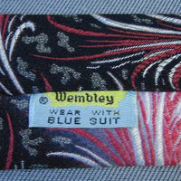 1950s vintage Wembley necktie label with close up of pink to black fade and pattern