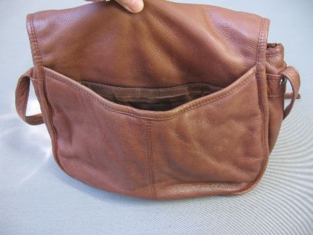 back view of leather bag, showing large easy access compartment