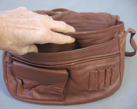 under the flap of leather bag, with multiple compartments big and small